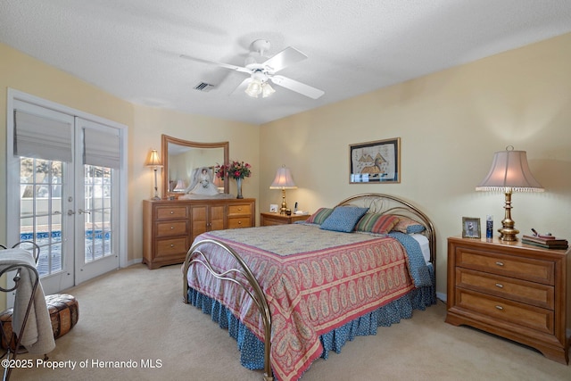 carpeted bedroom with french doors, ceiling fan, access to exterior, and a textured ceiling