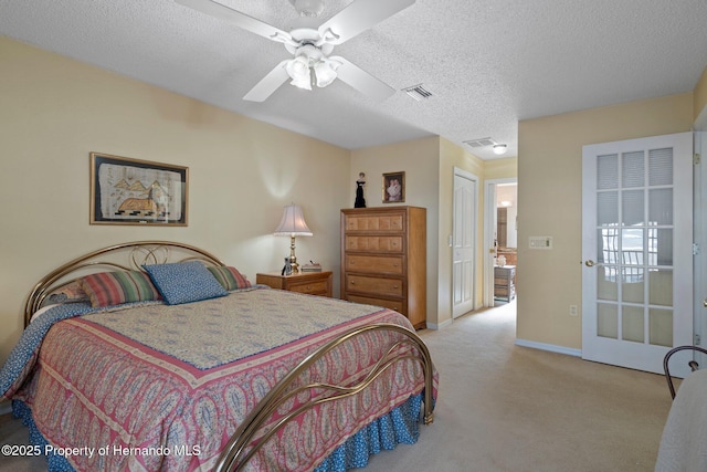 bedroom with ceiling fan, light colored carpet, a closet, and a textured ceiling