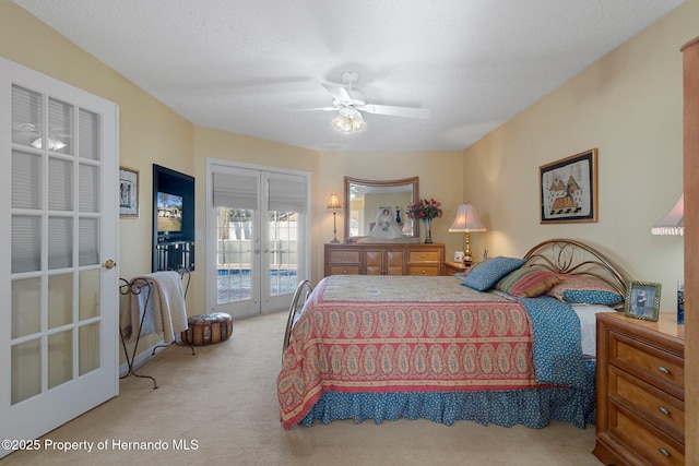 bedroom featuring light carpet, access to exterior, french doors, and ceiling fan