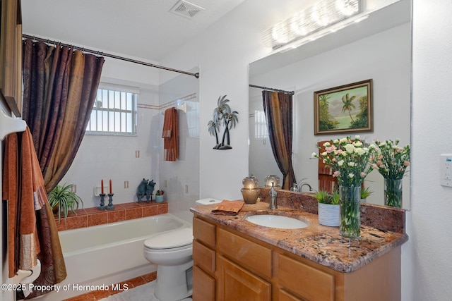 full bathroom featuring tile patterned flooring, shower / bath combo, vanity, and toilet