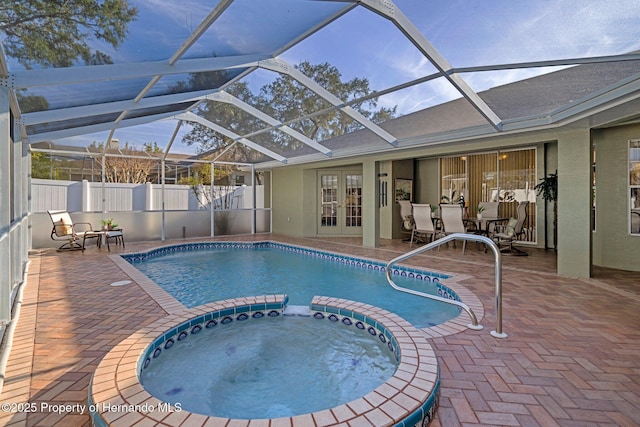 view of swimming pool featuring a patio, glass enclosure, an in ground hot tub, and french doors