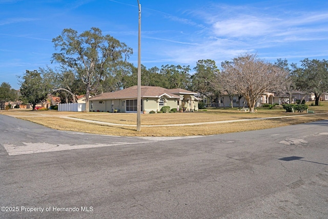 ranch-style home with a front lawn