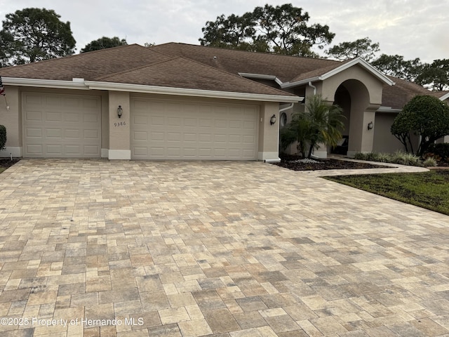 ranch-style home featuring a garage