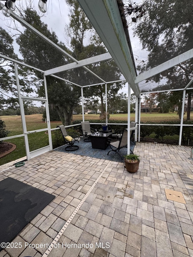 view of patio / terrace featuring glass enclosure