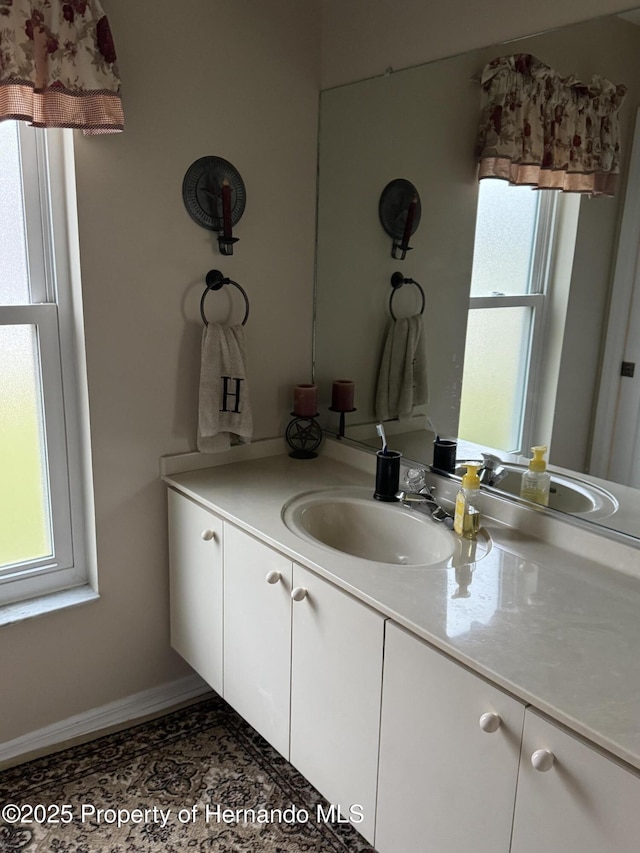 bathroom featuring vanity, tile patterned flooring, and a wealth of natural light