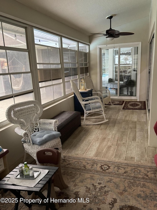 sunroom / solarium with ceiling fan and a wealth of natural light