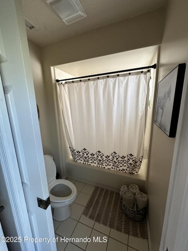 bathroom with toilet, shower / bath combo with shower curtain, visible vents, and tile patterned floors