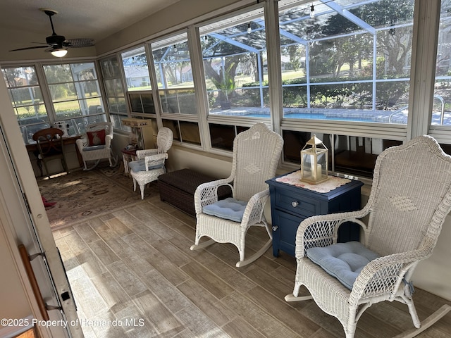 sunroom / solarium featuring a ceiling fan and plenty of natural light