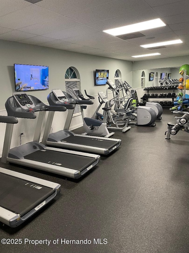 gym with a paneled ceiling