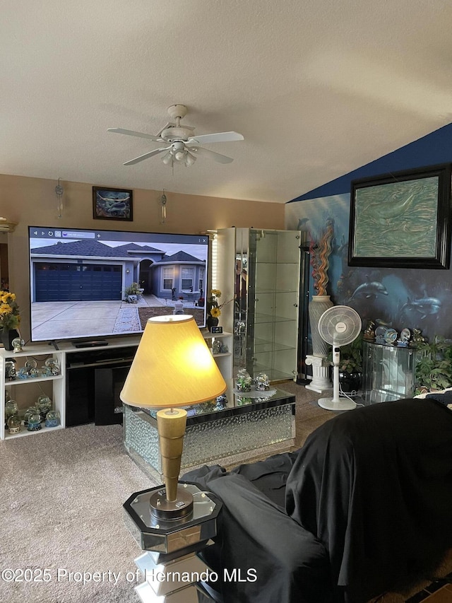 living room featuring carpet floors, a textured ceiling, and ceiling fan