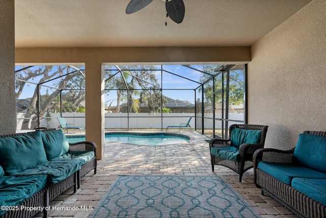 view of patio / terrace with an outdoor living space, glass enclosure, a fenced in pool, and ceiling fan