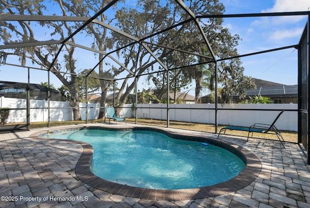 view of swimming pool featuring a patio, a fenced backyard, a fenced in pool, and a lanai