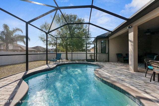 view of pool with a patio area, a lanai, and ceiling fan