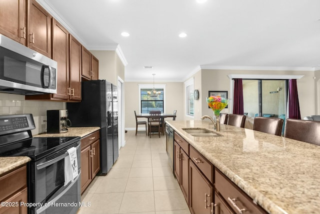 kitchen featuring light tile patterned floors, ornamental molding, a sink, stainless steel appliances, and backsplash