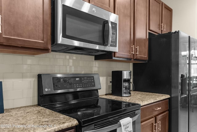 kitchen featuring stainless steel appliances and backsplash