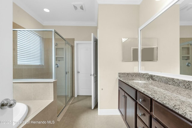 bathroom with ornamental molding, a shower stall, vanity, tile patterned flooring, and baseboards