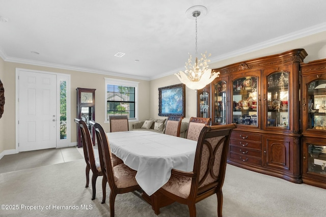 dining space with crown molding, light tile patterned floors, light carpet, a chandelier, and baseboards