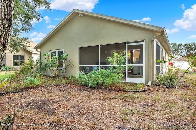 back of property with a sunroom