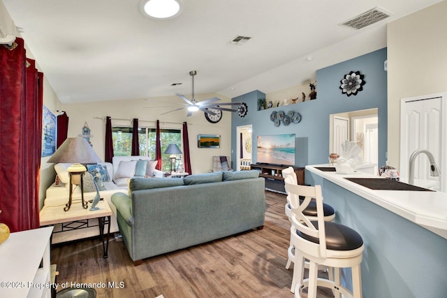 living room featuring ceiling fan, dark hardwood / wood-style flooring, and high vaulted ceiling