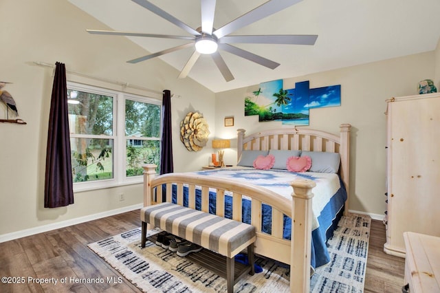 bedroom with ceiling fan, vaulted ceiling, and hardwood / wood-style flooring