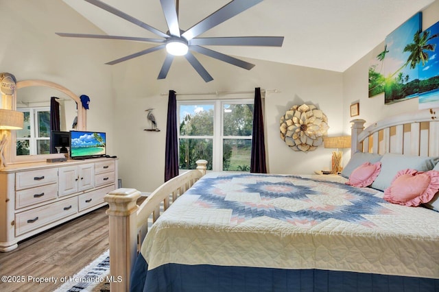 bedroom with vaulted ceiling, ceiling fan, and wood-type flooring