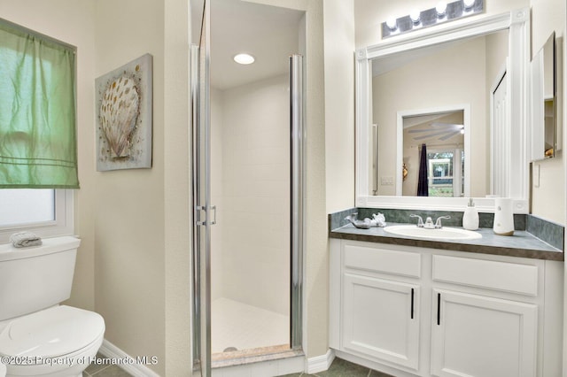 bathroom with tile patterned floors, toilet, walk in shower, and vanity