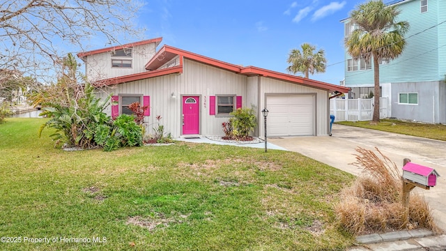 view of front of property with a garage and a front yard