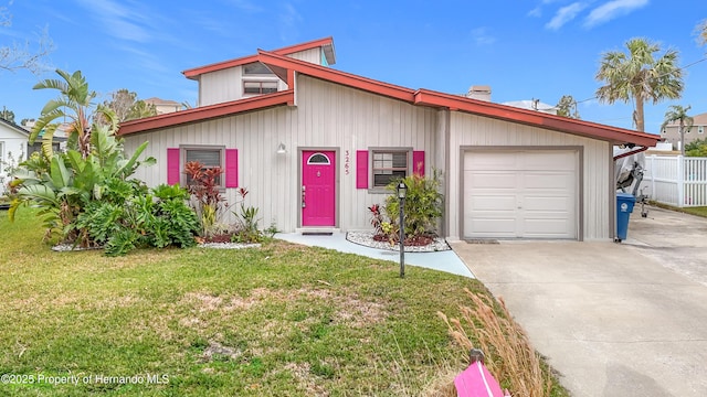 view of front of house with a garage and a front yard