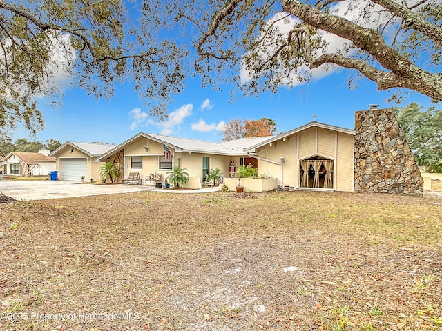 view of front of home with a garage and a front lawn