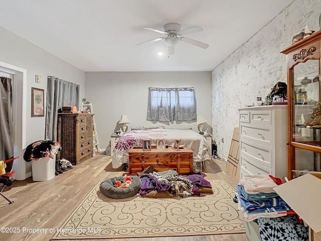 bedroom with light wood-type flooring and ceiling fan