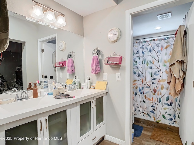 bathroom featuring curtained shower, hardwood / wood-style floors, and vanity