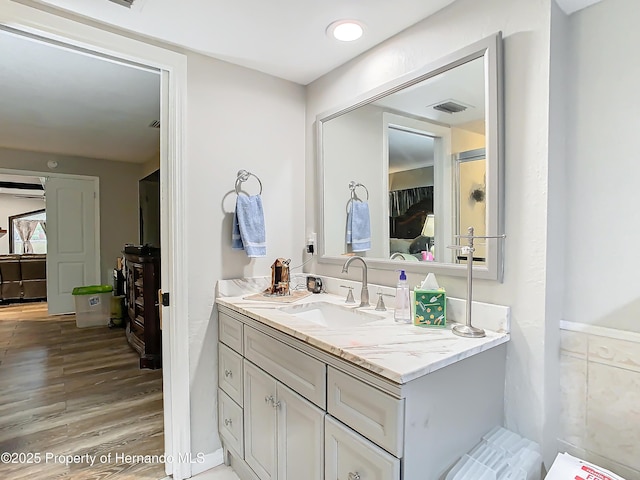 bathroom featuring hardwood / wood-style flooring and vanity