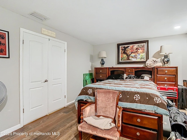 bedroom with light wood-type flooring and a closet