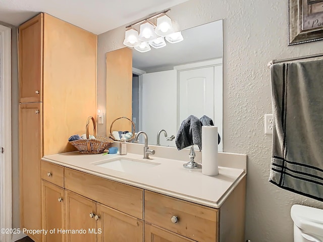 bathroom with toilet and vanity