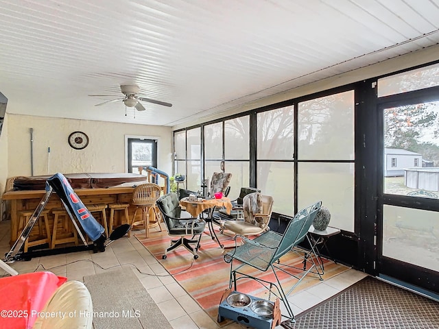 sunroom / solarium featuring ceiling fan