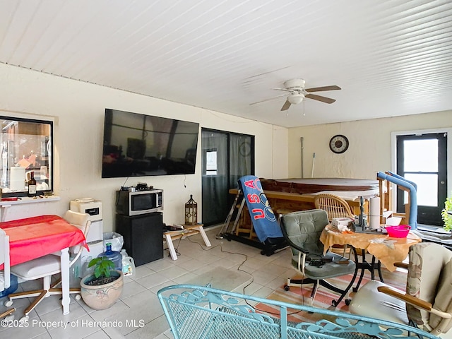 tiled living room with ceiling fan