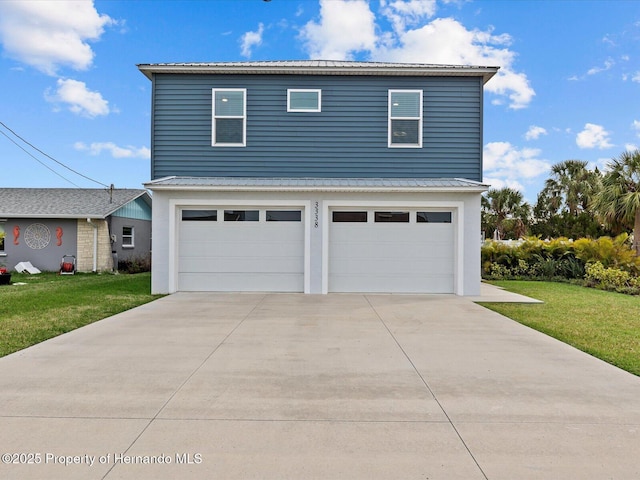 view of property with a garage and a front yard