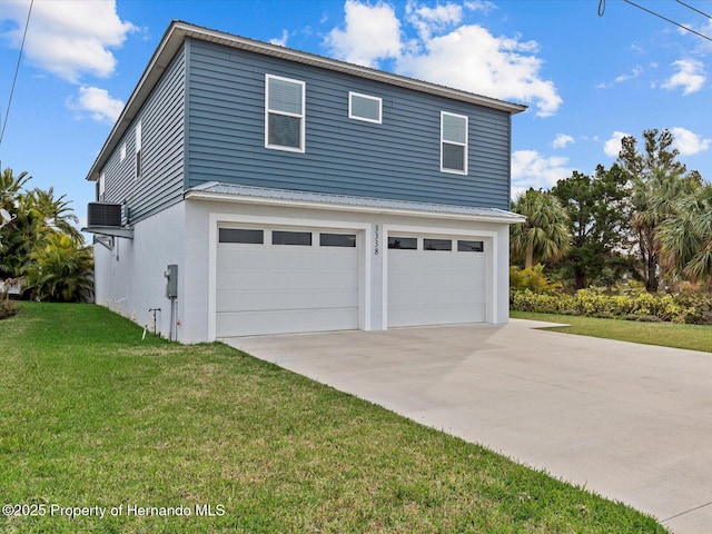 view of property exterior featuring a lawn, central AC unit, and a garage