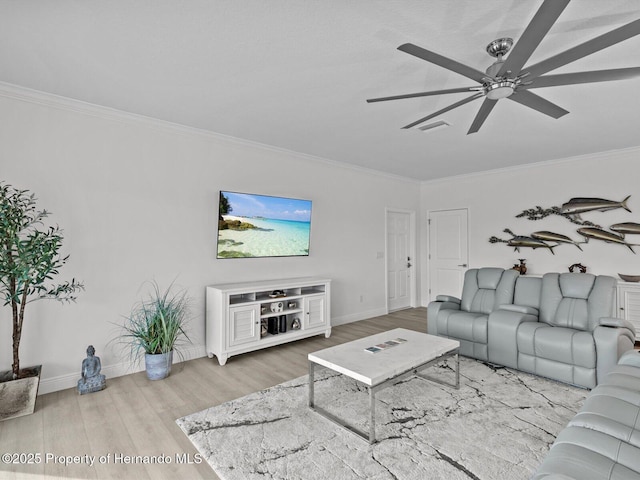 living room featuring ceiling fan, wood-type flooring, and ornamental molding