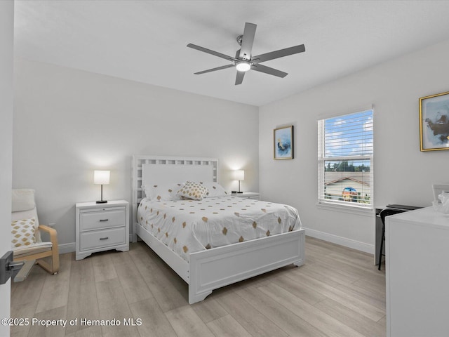 bedroom with ceiling fan and light wood-type flooring