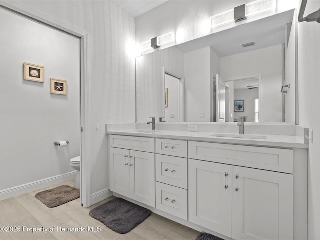 bathroom with toilet and vanity