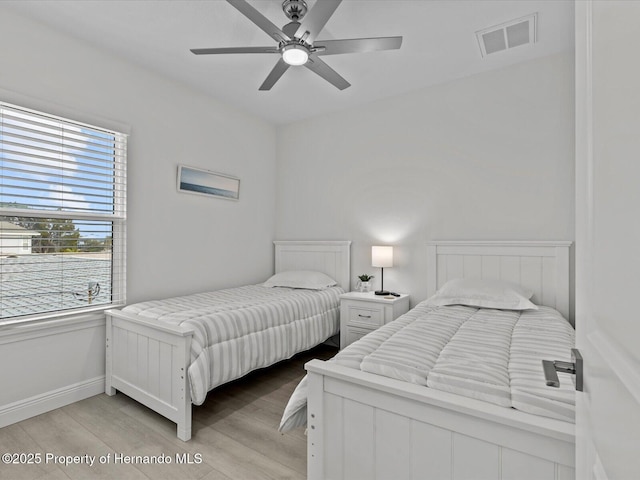 bedroom with light wood-type flooring and ceiling fan