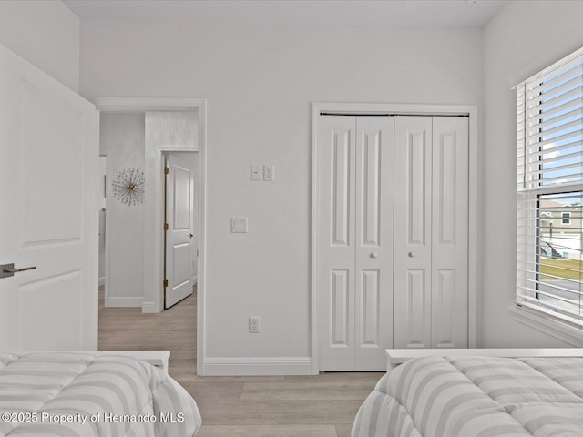 bedroom featuring a closet and light hardwood / wood-style flooring