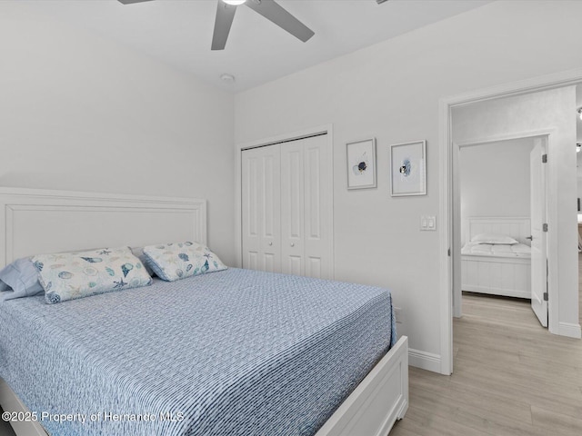 bedroom featuring ceiling fan, a closet, and light hardwood / wood-style floors