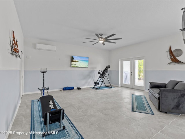 exercise room featuring ceiling fan, a wall mounted AC, french doors, and light tile patterned floors