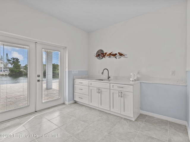 interior space with light tile patterned floors and sink