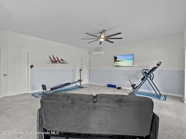 workout area with ceiling fan, light tile patterned floors, and a wall unit AC