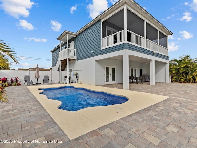 view of swimming pool featuring a patio area and french doors