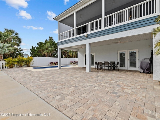 view of patio / terrace with ceiling fan, area for grilling, a balcony, and french doors