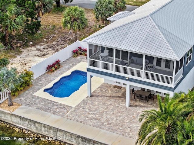 view of pool with a patio and a sunroom